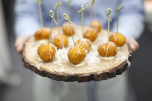 Nibbles presented on a wooden serving plate with parmesan