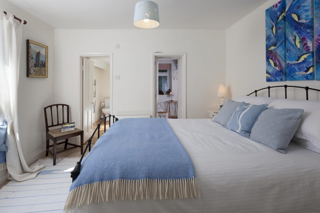Shot of a bedroom in a Cornish holiday home, showcasing the en suite