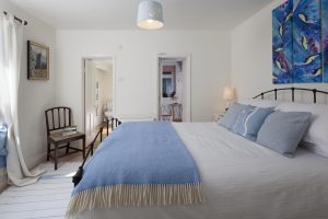 Shot of a bedroom in a Cornish holiday home, showcasing the en suite