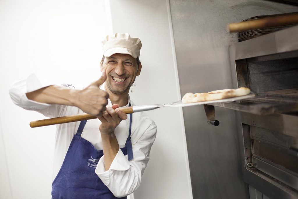 Photography of a man holding Pizza in Cornwall