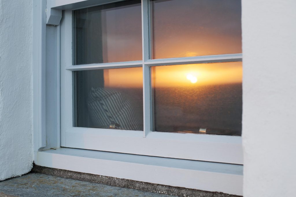 Sunset caught in the reflection of the window of the building