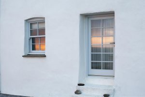 Sunset caught in the reflection of the window and door of the building
