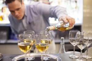 White wine being poured at the bar