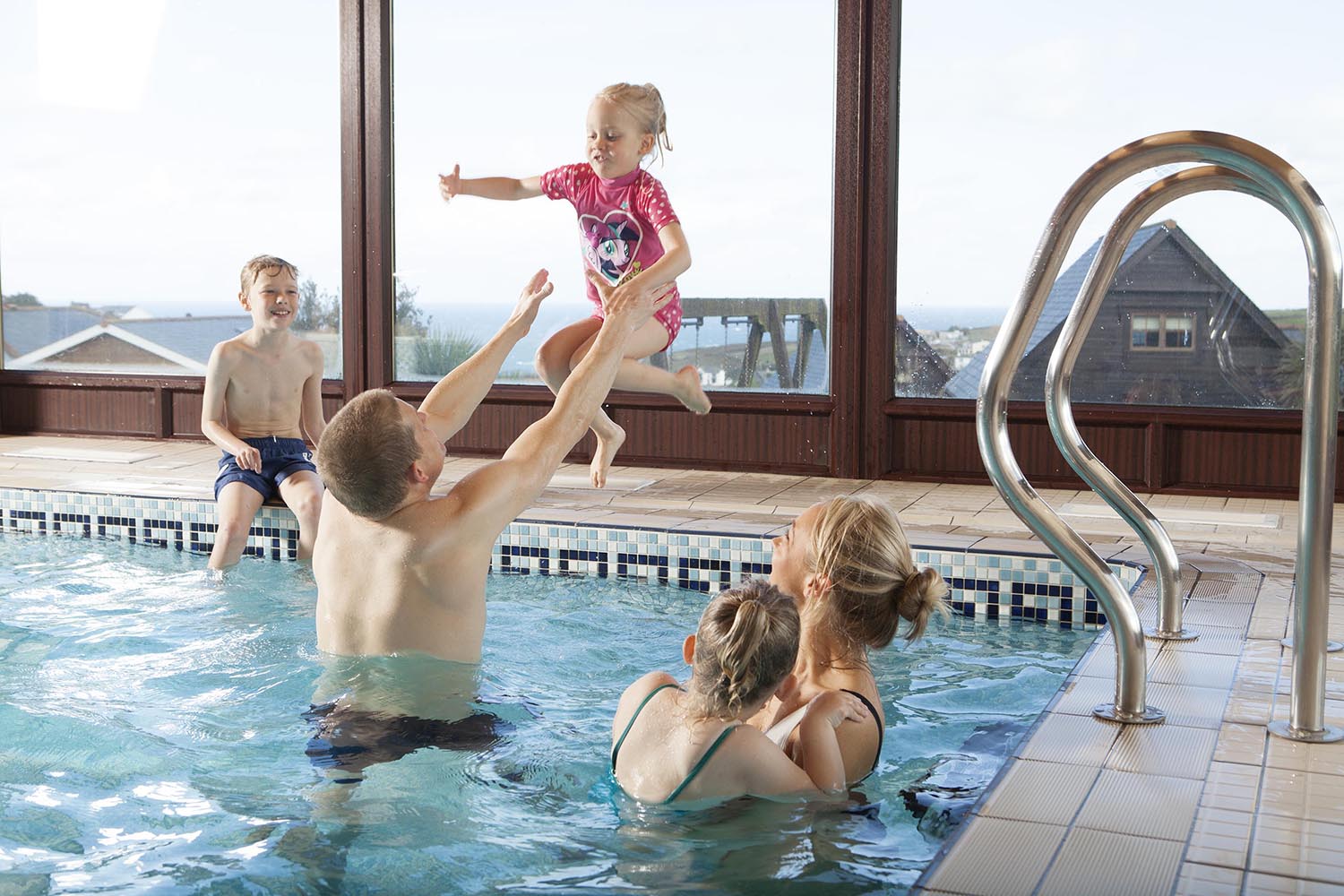 Daughter jumping into the hotel swimming pool