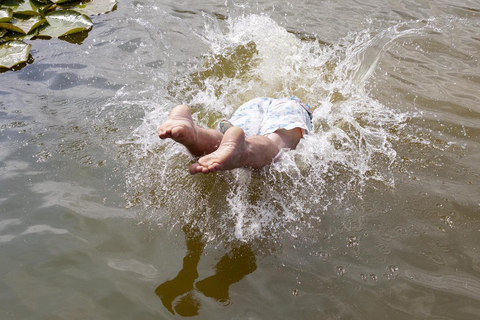 Man diving into pond