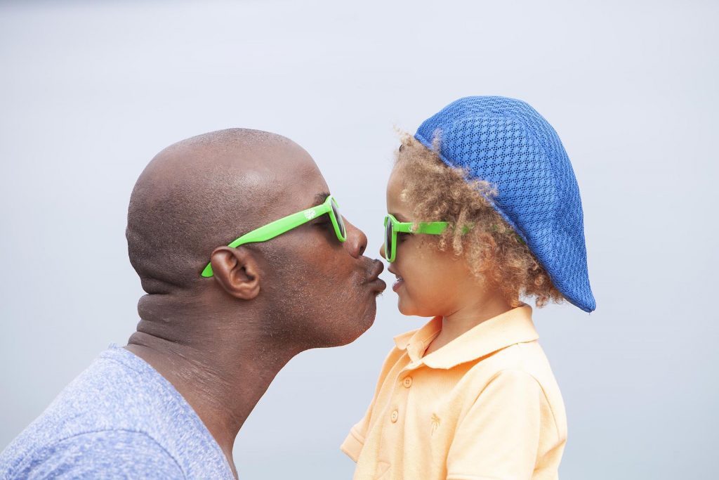 Father and son kiss